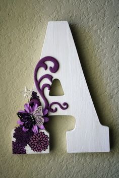 the letter a is decorated with purple and white flowers, and has a butterfly on it