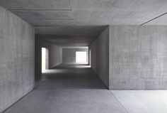 an empty room with concrete walls and flooring is seen in this image from the inside