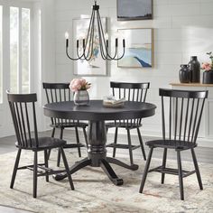 a dining room table with four chairs around it