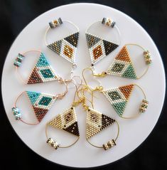 a white plate topped with lots of different types of earrings