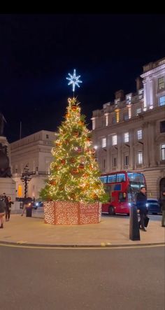 a large christmas tree in the middle of a street