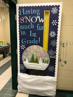 a classroom door decorated with snow globes and writing on the front, saying having snow much fun in 1st grade