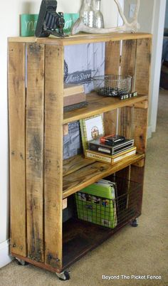 a book shelf made out of wooden pallets with baskets and books on the top