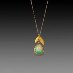 A magical faceted Ethiopian opal, wrapped in a warm 22k gold bezel is suspended from a 22k gold double leaf charm in this stunning necklace. The opal is backed with sterling silver, and measures approximately 1/2 inch tall. The leaf and opal together measure approximately 1 inch, and hang from a 14k gold chain. Matte finish. Luxury Unique Ethiopian Opal Jewelry, Yellow Gold Opal Teardrop Pendant Necklace, Gold Teardrop Opal Necklace, Gold Opal Teardrop Pendant Necklace, Yellow Gold Teardrop Opal Necklace, Handmade Gold Opal Necklaces, Handmade Opal Gold Necklace, Handmade Gold Opal Necklace, Handmade Gold Necklace With Ethiopian Opal