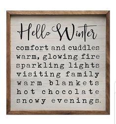 a wooden framed sign that says hello winter comfort and cuddles warm, glowing fire sparkling