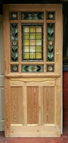 a wooden door with stained glass panels on it