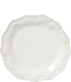 a white plate with an ornate design on the rim and bottom, against a white background