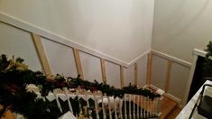 the stairs are decorated with christmas garlands and stockings for holiday decorating, as well as other decorations