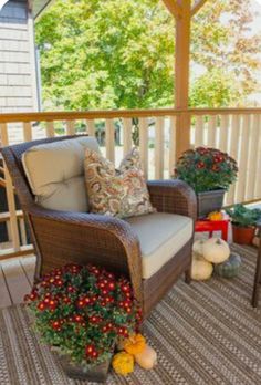 a chair and table on a porch with christmas decorations