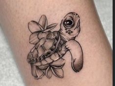 a small turtle tattoo on the leg