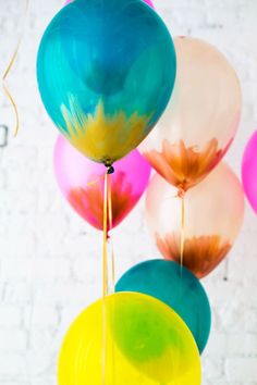 colorful balloons are floating in the air with streamers