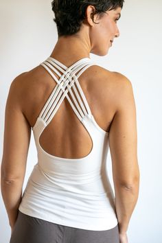 The woven back yoga tank top features a distinctive design of stitched fabric strands interlaced mid-back in a graceful woven pattern. Comfortable, form-fitting and flattering, it offers casual elegance that's also fun. Great for yoga or casual wear. This inventive top is versatile enough to be worn alone or underneath other layers for a stylish look. Features a fitted soft inner bra liner with elastic support. Deliciously soft fabric with great stretch that holds its shape well. This fabric is Ws Sport, Bra Liner, Back Yoga, Yoga Tank Top, Long Tank Tops, Long Tank, Outer Wear, Yoga Tank, Yoga Tank Tops