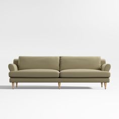 a beige couch sitting on top of a white floor