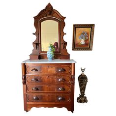 This Eastlake Victorian dresser, hailing from the early 1800s, is imbued with the refined aesthetic of its time. The dresser's burl wood veneer is indicative of its status as a piece belonging to a discerning middle to upper-middle class Victorian home. It is characterized by its functionality and the ornate craftsmanship of the era, evident in the hand-made dovetail joints and smoothly functioning drawers. -Hand-crafted dovetail joints on drawer fronts and backs, showcasing the high-quality cra Eastlake Dresser, Antique Dresser With Mirror, Victorian Dresser, Marble Top Dresser, Victorian Apartment, Eastlake Victorian, Mirror Dresser, Victorian Dressers, Wood Furniture Plans