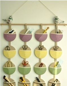 a wall hanging made out of circles with scissors and other items on it's hooks