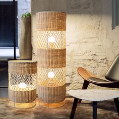 two wicker lamps sitting next to each other