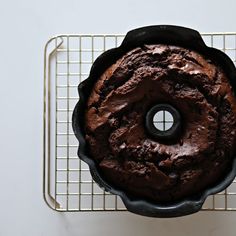 a chocolate cake sitting on top of a cooling rack