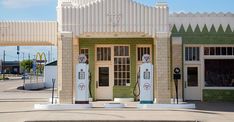 an old fashioned gas station with three pumps