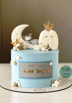 a blue cake decorated with stars, moon and teddy bears