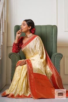 1.Fabric: Satin with Banarasi Weaving 2.Work: Intricately zari woven borders and floral bootas across the body. Rich woven palla in shades of red and gold. The borders have a zari and sequin lace for the extra glamour. 3.Colour: Cream with Red Border 4.Length: 5.5 metre Width: 44 inches approx 5.Blouse piece: Colour:Maroon Fabric: Velvet Length: 1 metre(unstitched) Work: Fully embroidered sleeves and Neckline(as worn by model) 6.Care: DRY WASH ONLY. NEVER WASH EMBROIDERED FABRICS. 7.Despatch Time: 15 days. Note: 2.We try our best to stay true to the actual colour of the product. There may however be slight difference (5-10%) in the colour of the actual product due to lighting/phone display settings. Maroon Fabric, Phone Display, Embroidered Sleeves, Red Border, Banarasi Saree, Banarasi Sarees, Stay True, Shades Of Red