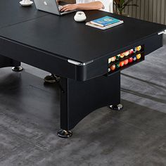 a man sitting at a table with a laptop on it