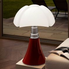 a red lamp sitting on top of a wooden table