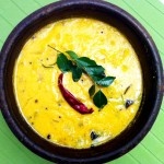 a bowl filled with soup on top of a green table