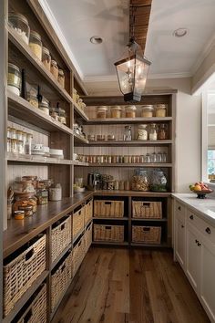 a kitchen filled with lots of wooden shelves and wicker baskets on top of it