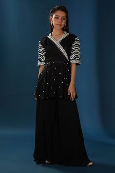 Black short angrakha with resham,dabka,sequins and white pearl embroidery. Paired with coordinating sharara. - Aza Fashions Bollywood Style Embellished V-neck Kurta, Embellished V-neck Kurta For Party, Traditional V-neck Sharara For Party, Navratri V-neck Mirror Work Sets, Festive V-neck Kurta For Party, Festive Designer V-neck Sharara, Diwali V-neck Sets With Mirror Work, Traditional Wear With Mirror Work And V-neck, Fitted Anarkali Bandhgala With Mirror Work