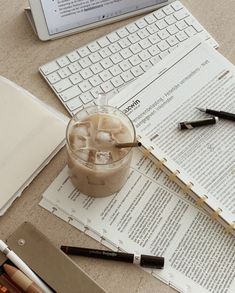 an open laptop computer sitting on top of a desk next to a cup of coffee