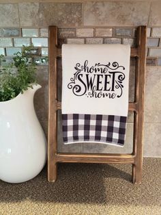 a white vase sitting next to a towel rack on top of a carpeted floor