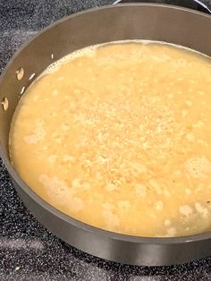 a pan filled with food sitting on top of a stove