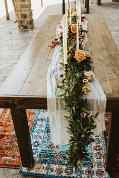 a long table with candles and flowers on it