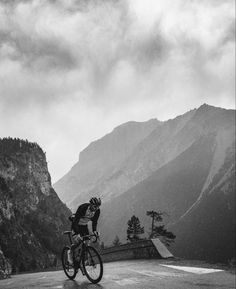 a man riding a bike on top of a mountain