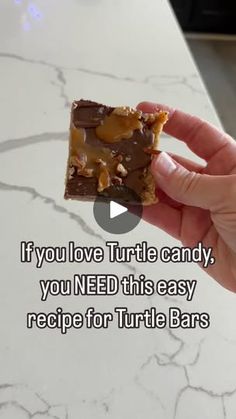 someone holding up a piece of food with the words if you love turtle candy, you need this easy recipe for turtle bars