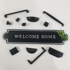 a welcome home sign surrounded by black objects