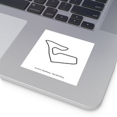 a laptop computer with a sticker on the keyboard