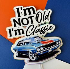 an old car sticker on top of a blue and orange background with the words i'm not old, i'm classic