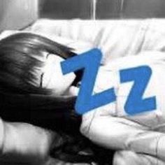 a woman laying on top of a couch next to a blue zzz text over her head