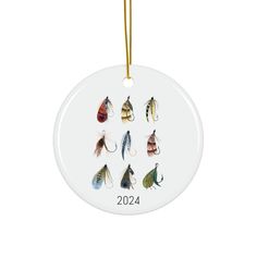 a white ornament with six different colored flies on it's front and side