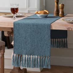 a blue table runner with tassels on it