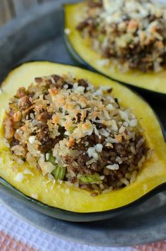 sausage and rice stuffed squash on a plate with text overlay that reads sausage and rice stuffed squash