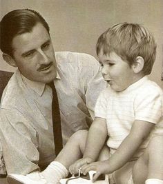 a man holding a small child in his lap