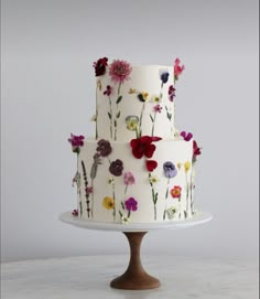 a three tiered cake with flowers on it