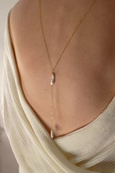 This simple and dainty back drop necklace features two freshwater biwa pearls and looks great with backless tops and dresses. There is no clasp, it is completely reversible, so you can wear it in the front over a sweater or tee. So lightweight - you won't even know it's on! Closure: none Materials: 14K gold filled or sterling silver Measures 26" ; Drop measures: approx 4" Handmade in New York Minimal Jewelry Earrings, Christine Elizabeth, Fall Wedding Jewelry, Affordable Fine Jewelry, Elizabeth Jewelry, Star And Moon Necklace, Backdrops Necklace, Horseshoe Necklace, Biwa Pearls