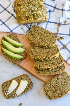 slices of bread on a cutting board next to sliced avocado