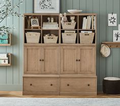 a living room filled with furniture and baskets on top of it's shelves in front of a wall