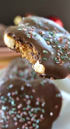 chocolate covered cookies with sprinkles on a plate