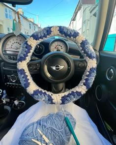 the interior of a car with a blue and white steering wheel cover on top of it