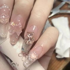 a woman's hand with some pink and gold nails